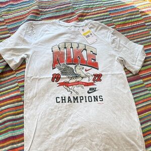 Nike White Graphic 'Champions' Short Sleeve Tee with Red/Black Accents